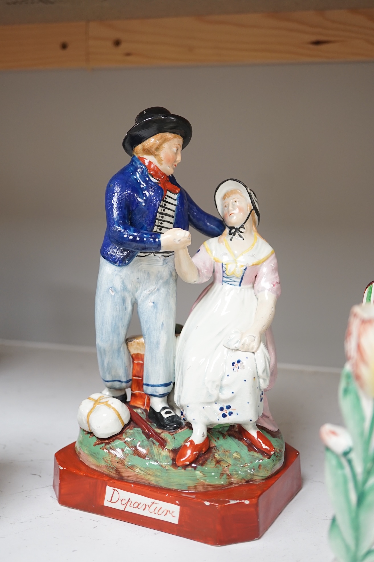 Six mid 19th century Staffordshire figures or groups: a pair titled ‘my grandmother and my grandfather’, a double sided water/gin figure, a pair of figural spill vases and a pearlware group titled ‘Departure’, the talles